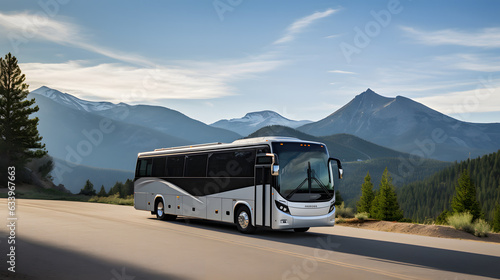 Exterior shot of a modern tour bus parked near a scenic lookout with mountains in the background.