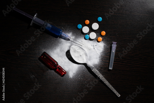 Top view of cocaine with injection and tablets