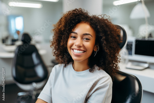 Smiling young woman in dental chair