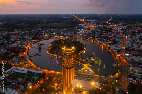 Aerial view of Roi Et tower, tourist attraction landmark. Urban housing development from above. Top view. Real estate in city, Thailand. Property real estate at night.