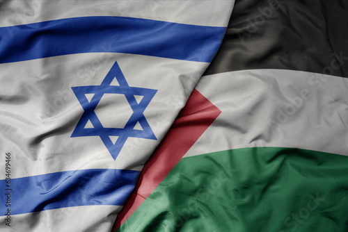 big waving realistic national colorful flag of israel and national flag of palestine .