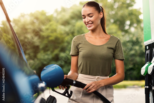 Lady Filling Up Car With Fuel at Modern Gas Station