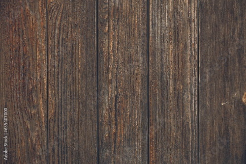 Dark wooden background, texture of brown woody board, grunge wallpaper. Old wood floor, rustic timber wall. Vintage slats, vertical pattern, natural plank surface. Weathered panel. Textured oaken door