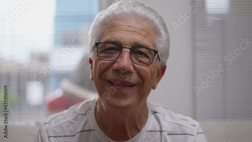 Headshot portrait of Elderly man nodding yes to camera smiling. affirming conversation, close-up face of senior person listening attentively