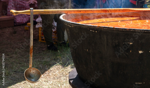 Tomato soup with pasta is a dish of Polish cuisine. Hot Zupa pomidorowa in a large cauldron at the field kitchen at a food fair. A popular soup made from grated tomatoes in their own juice.