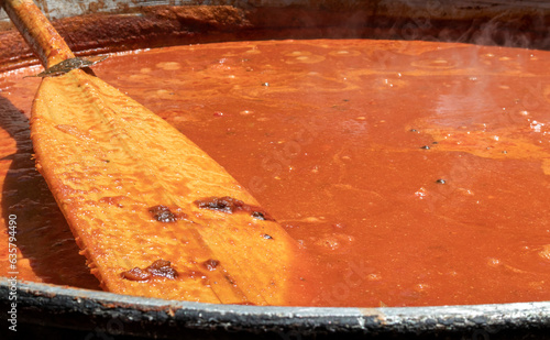 Tomato soup with pasta is a dish of Polish cuisine. Hot Zupa pomidorowa in a large cauldron at the field kitchen at a food fair. A popular soup made from grated tomatoes in their own juice.
