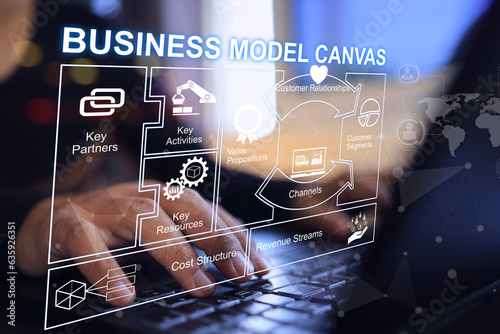 Business person working on business model canvas BMC on laptop in office to business investment consider. Startup business planning concept. Partner costructure chanel customer segment analysis.