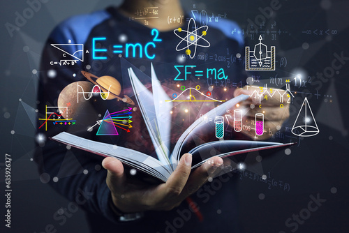 A student or physics scientist open a book to study theory of physics law of planetary gravitation motion and general relativity equation or light spectrum. Albert einstein and sir isaac newton laws