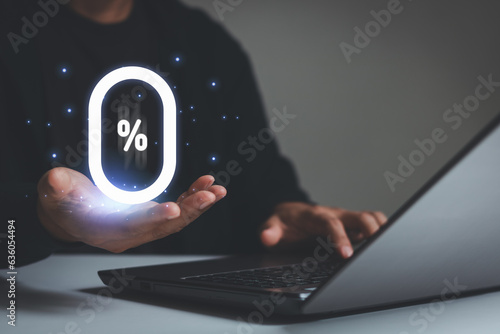 Businessman holding glowing zero percentage or 0 percent for special offer of shopping department store and discount concept. 0% interest rate, installment payment, promotion, marketing, boost sales.