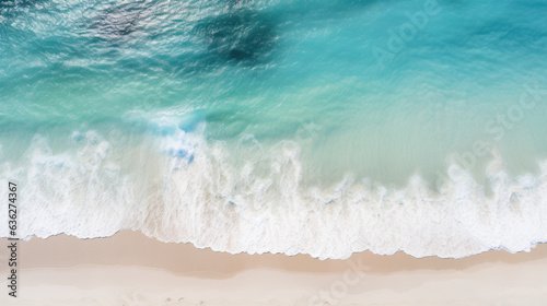 Overhead photo of crashing waves on the shoreline beach. Tropical beach surf. Abstract aerial ocean view