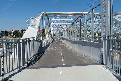 Pedestrian and bicycle footbridge along the railway bridge, connecting Grzegórzki with Zabłocie in Krakow, Poland. Train viaduct and walkway spanning over the Vistula River in Cracow, Wisła Kraków.