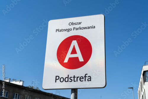Sign indicating paid park zone A in Krakow, Poland. Road traffic information name plate for car parking in Kraków. Obszar płatnego parkowania means paid parking area, Podstrefa means subzone.