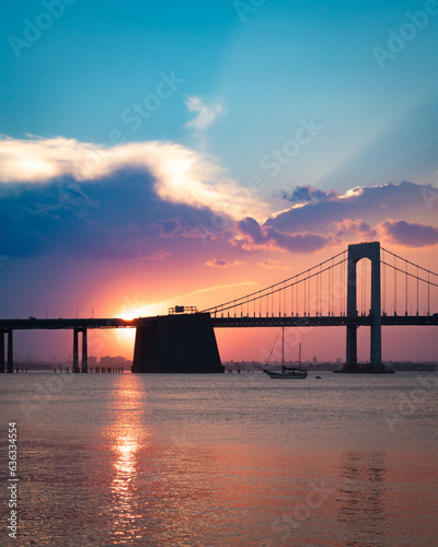 Beautiful view of the Throgs Neck Bridge seen from Bayside Queens looking towards the Bronx, New York City seen during colorful sunset.