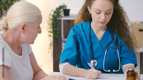 Woman therapist writing down medical records while listening to patient's complains