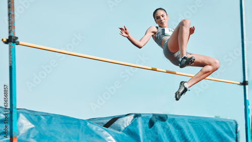 High jump, woman and fitness with exercise, sport and athlete in a competition outdoor. Jumping, workout and training for performance with action, energy and contest with female person and athletics