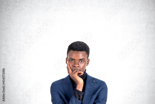 Young African American businessman thinking, portrait