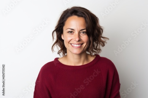Portrait of a smiling woman in a red sweater on a white background