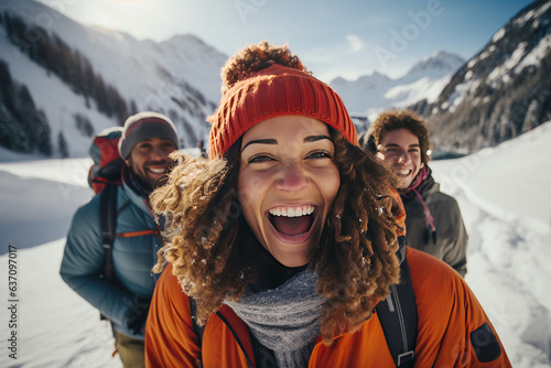 Multi-racial group of young friends, hiking in the snow in the mountains.