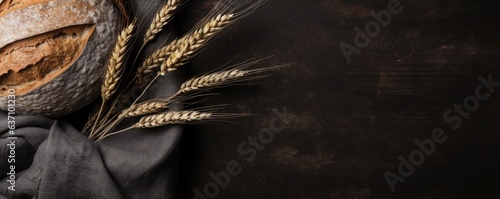 different types of bread and wheat ears on wooden table background, flat lay, a view from the top, banner concept