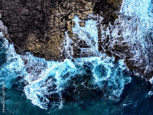 Dramatic scene of powerful waves crashing against the rocky shoreline