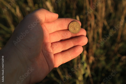 Coin ten pfennig in hand