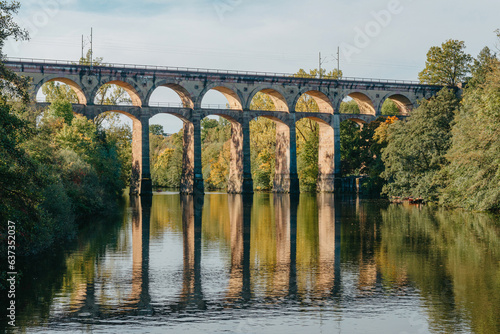 Railway Bridge with river in Bietigheim-Bissingen, Germany. Autumn. Railway viaduct over the Enz River, built in 1853 by Karl von Etzel on a sunny summer day. Bietigheim-Bissingen, Germany. Old