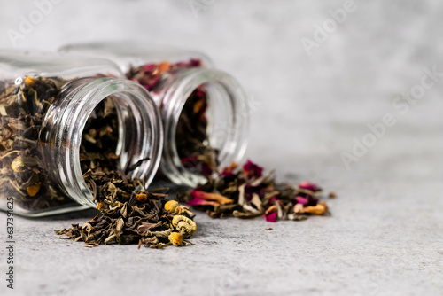 Close up shot of dry tea in glass jar with defocused background and copy space.