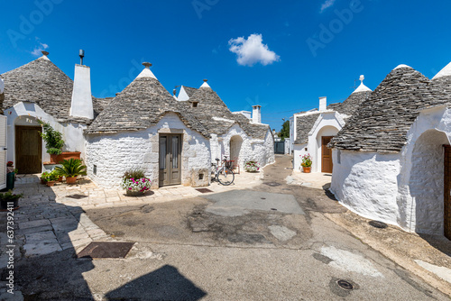 Alberobello, Italy - July 21, 2021: The Trulli of Alberobello in Apulia in Italy. These typical houses with dry stone walls and conical roofs are unique to the world