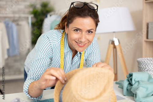 hat maker working on design in studio