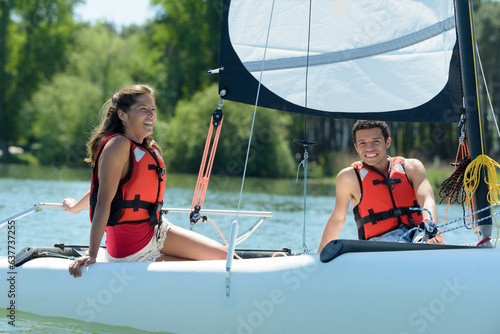 a happy young couple sailing