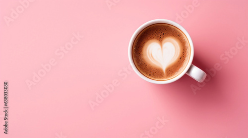top down picture of a cup of cappuccino on pink background, with space for text