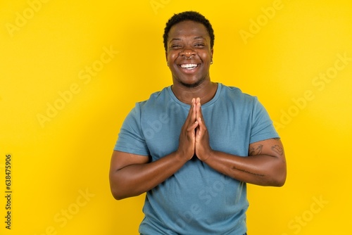 MODEL praying with hands together asking for forgiveness smiling confident.