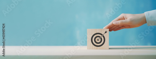 Goal and planning concept, Hand holding wooden block with target aiming dart board, Business achievement objective goal and project progress growth value processing marketing financial, Reach target