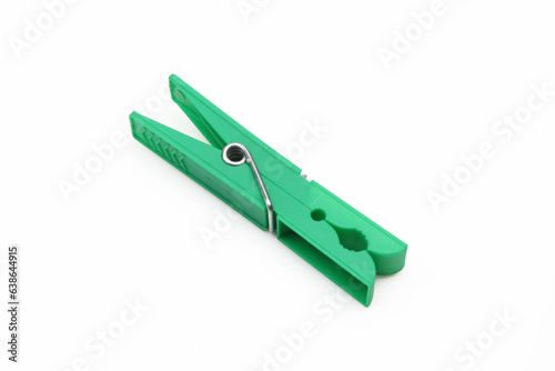 Plastic green clothespin isolated on white background