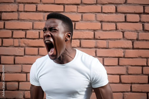 Anger African Man In White Jeans On Brick Wall Background