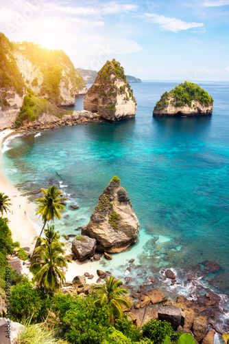 Tropical beach with white sand and palm trees, beach holiday destination on Bali island