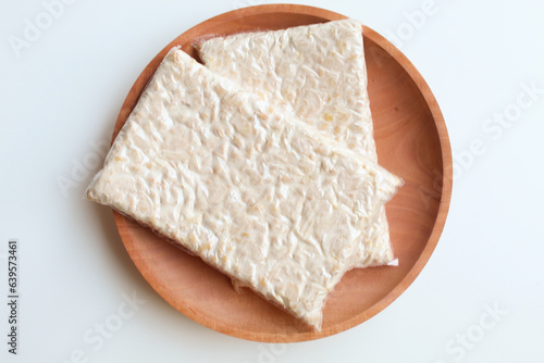 Tempeh or tempe, processed soy product, on wooden background. Isolated on white background. Flat lay or top view