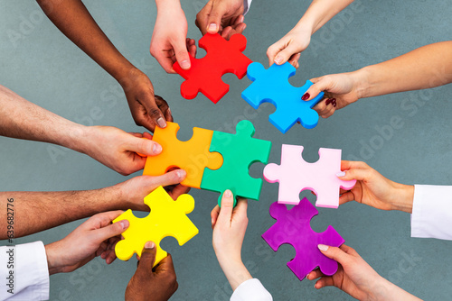 High Angle View Of Medical Team Solving Jigsaw Puzzle