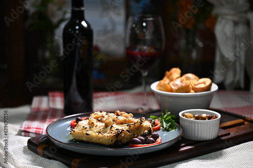 typical portuguese dish roasted codfish with onion garlic peppers and rustic babata lusitanian food