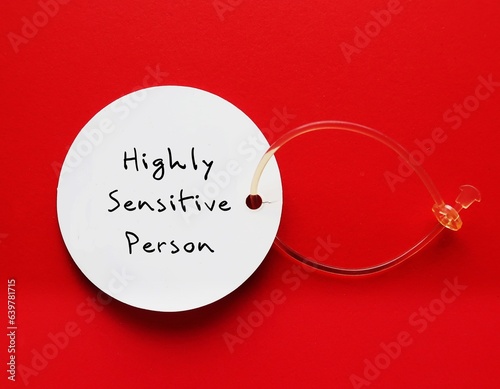 Tag on red background with handwritten text HIGHLY SENSITIVE PERSON, refers to people who think and feel everything more deeply, more sensitive to the environment and social interactions