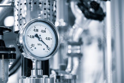 Industrial concept. equipment of the boiler-house, - valves, tubes, pressure gauges, thermometer. Close up of manometer, pipe, flow meter, water pumps and valves of heating system in a boiler room.