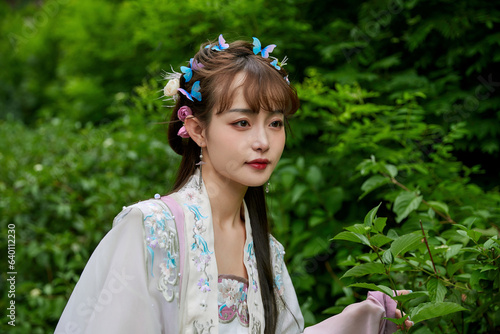 An Oriental beauty in ancient attire holding an umbrella