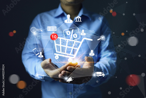 Seller or merchant is holding shopping cart to sales through online store marketplaces promotion discount percentages to attract customers to boost sales as a marketing strategy.