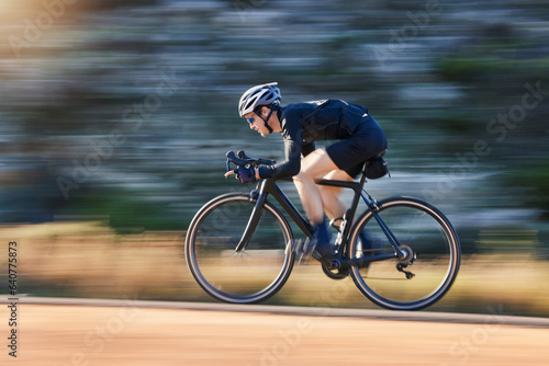 Motion blur, speed and cyclist on bicycle on road in mountain with helmet, exercise adventure trail and fitness. Cycling race, nature and man with bike for fast workout, training motivation or energy