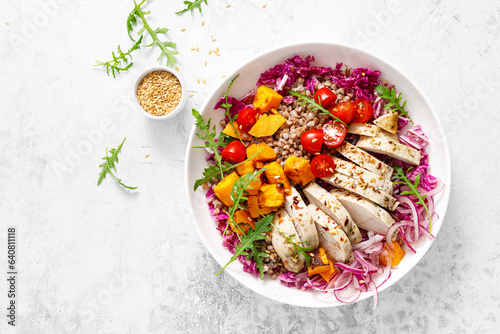 Chicken breast fillet and buckwheat bowl, grilled butternut squash and fresh vegetable salad with arugula and tomatoes, healthy food, lunch menu, top view