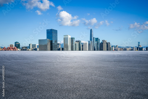 Asphalt road and city skyline with modern buildings scenery