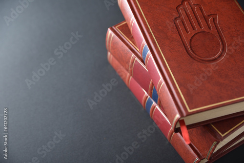 Stack of books with engraved symbol jain elevated view