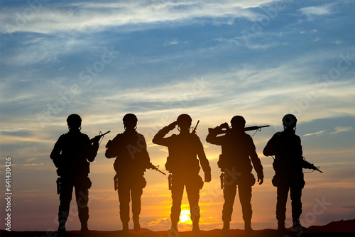Military silhouettes of a soldiers against the sunset. Concept - Armed Force