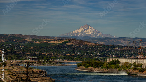 Mt. Hood seen behind surrounding village and river 
