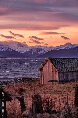 Stormy sunrise with old fishing cabin on Godøy, Ålesund, Norway